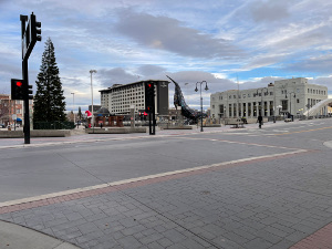 Virginia Avenue is in the foreground, a Christmas tree in the left foreground, and the tail fluke of a large sculpture of a whale in the park.